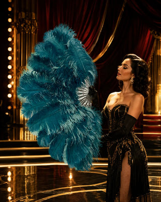 Seafoam ostrich feather fan with teal accents and clear staves modeled on a luxury cabaret stage