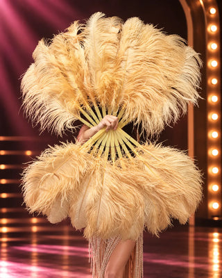 Champagne beige ostrich feather fan pair with matching staves in glamorous stage setting
