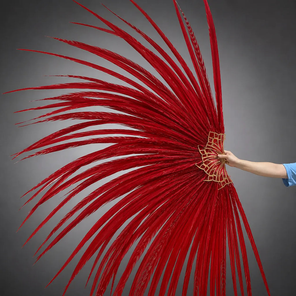 Grand Performance Ringneck Pheasant Feather Fan in red shown in motion on a luxury Art Deco stage